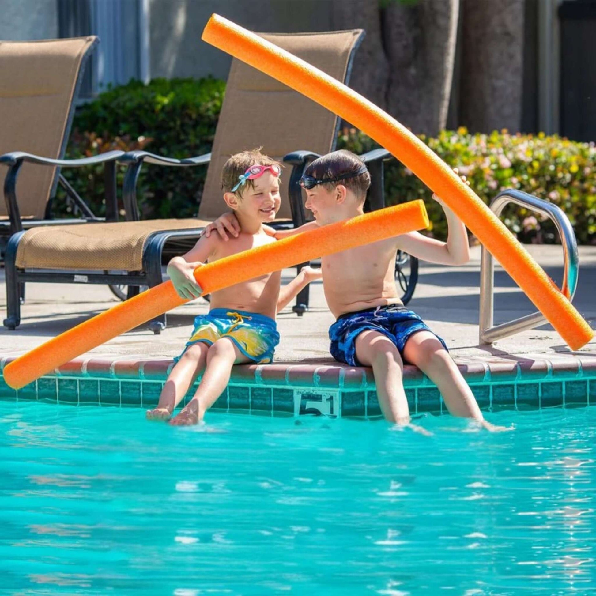Kids playing with Deluxe Foam Swim Noodles | Orange | Black | Purple | 47" x 2.25" by SOS Pool, enjoying pool fun.