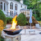 Outdoor scene featuring Grand Effects Corinthian Fire Bowl with flames, modern design, and SOS Pool vibes, SKU: GF30C.