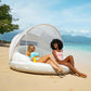 Two women relaxing on the beach in an INTEX Canopy Island Inflatable Pool Float, SKU 58292EP, enjoying sunshade and drinks.