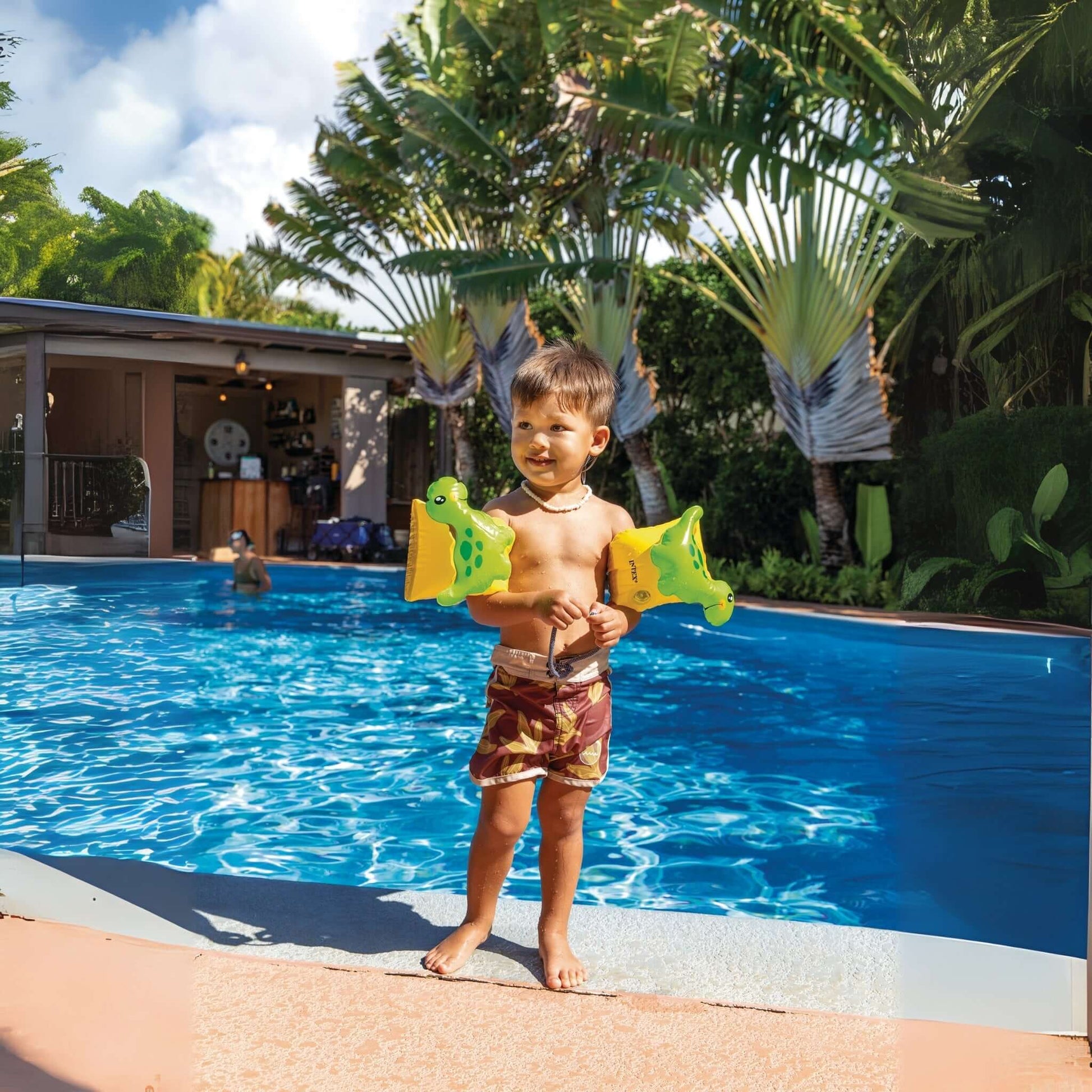 A toddler standing by a pool, wearing Dinosaur Arm Bands, enjoying water play, product SKU: 32132J, SOS Pool.