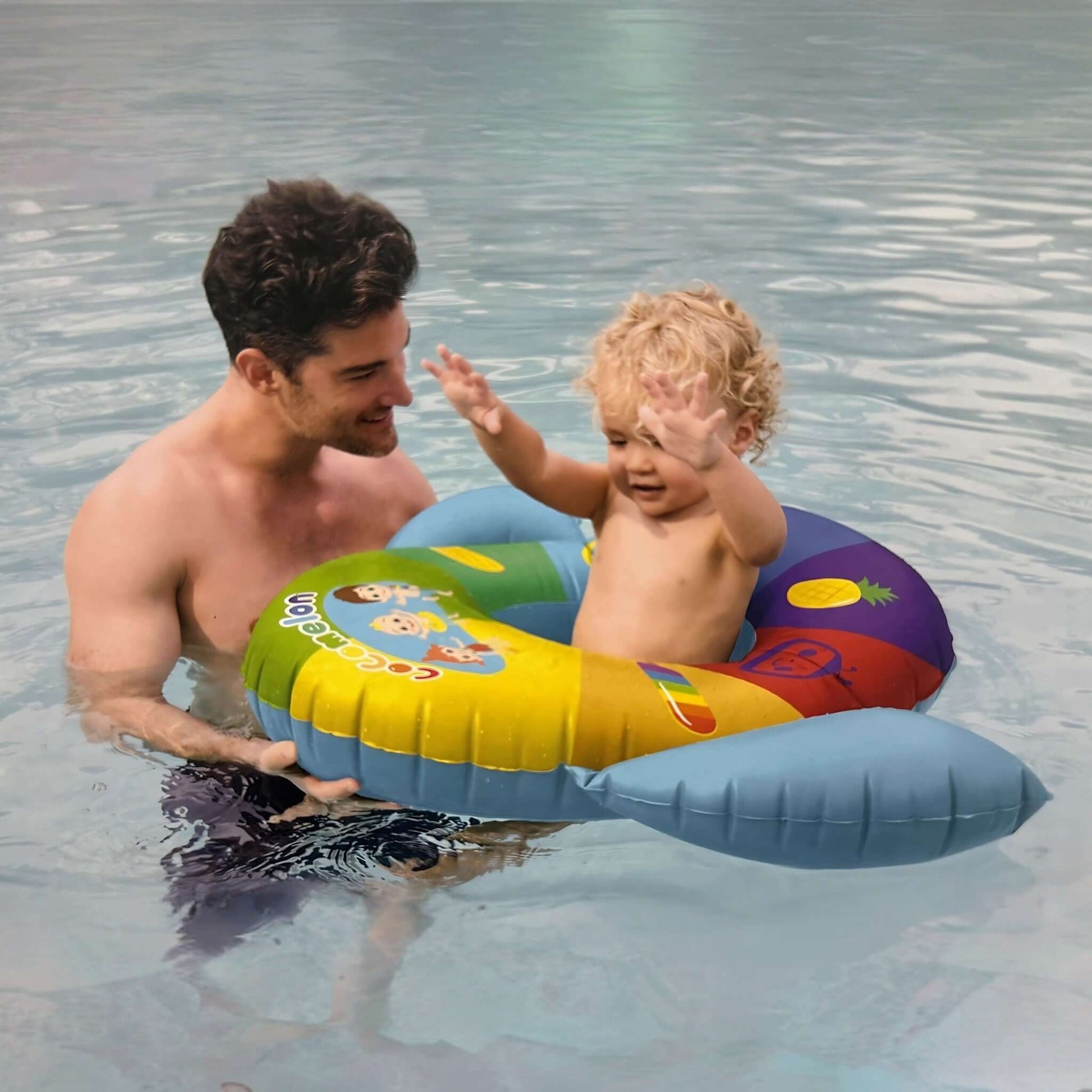SwimWays Cocomelon Inflatable Baby Boat in use at the pool with an adult and a toddler, SKU 6071744.