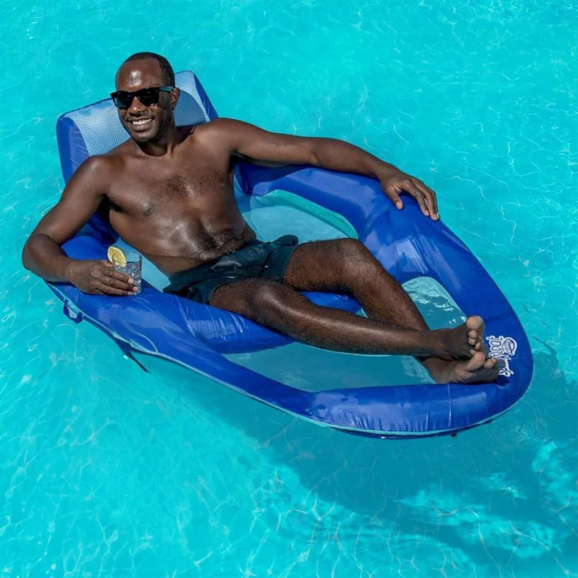 Man relaxing in SwimWays Spring Float Recliner XL in pool, enjoying luxury lounging, SKU 6069706, SOS Pool.