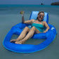 Woman relaxing on the SwimWays Spring Float Recliner XL in blue in the ocean, sipping a drink, SKU 6069706.